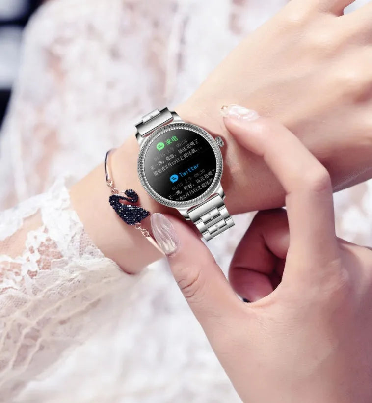AK38 ladies smart watch with stainless steel Milanese band and a lit 1.09-inch colour screen.