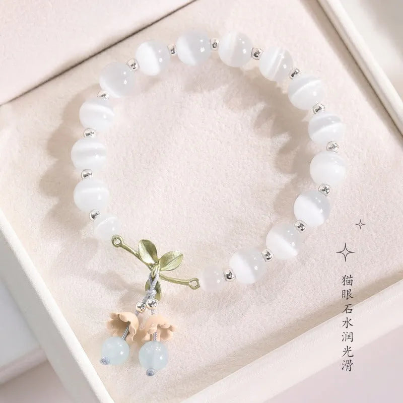 Close-up of a women's electroplated opal cat's eye stone beaded bracelet with diamond-shaped beads.