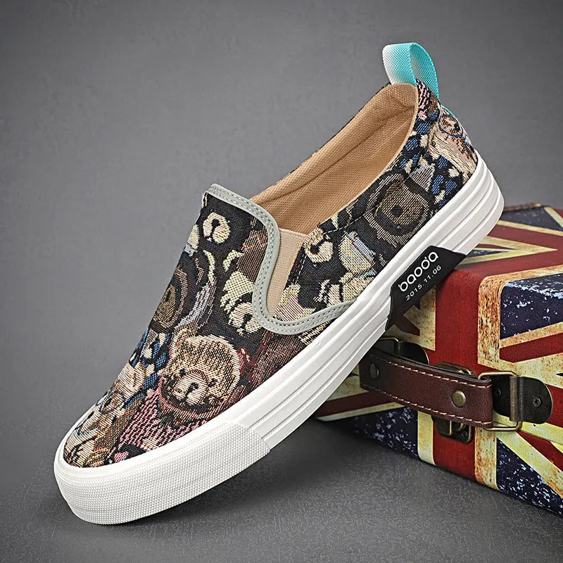 A pair of low-top canvas slip-on sneakers with a round toe and vulcanised rubber sole on a neutral background.