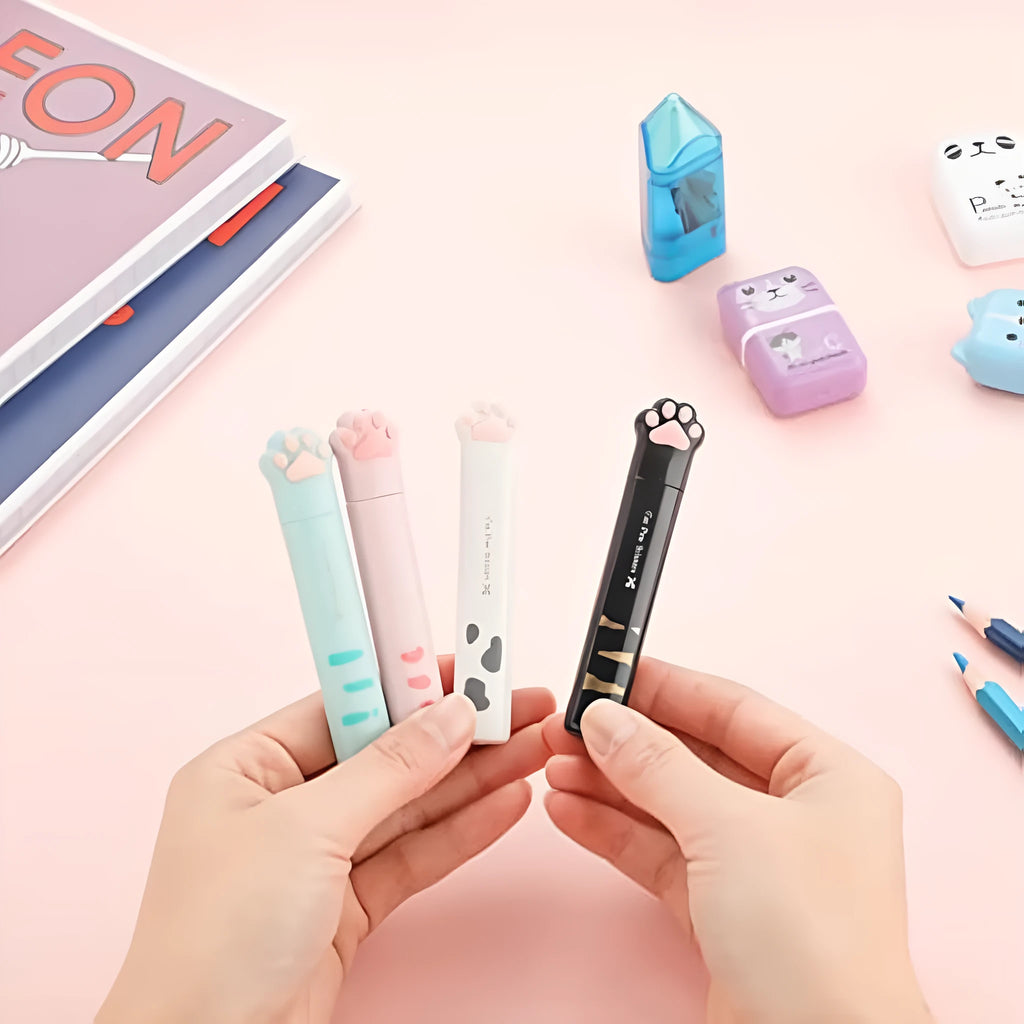 Cat paw design mini folding safety scissors in four colours: black, blue, pink, and white.