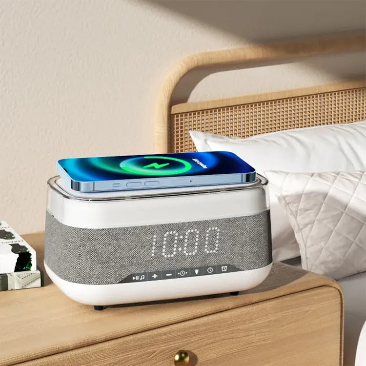White multifunctional alarm clock with Bluetooth speaker and wireless charging pad on a table