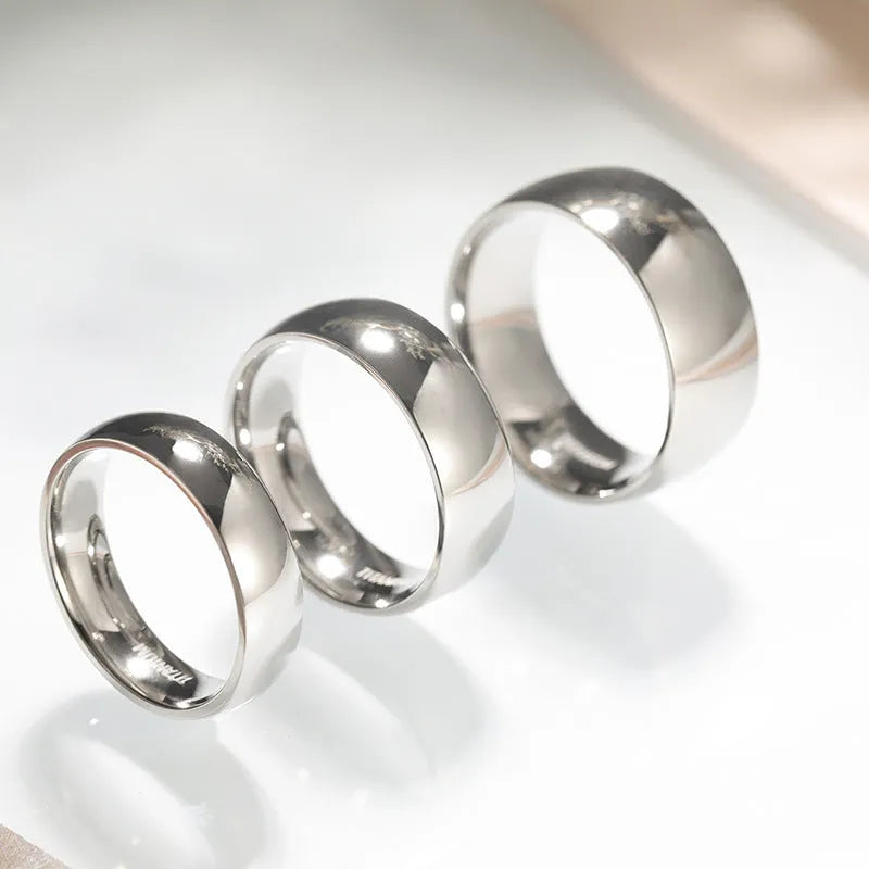 Silver titanium steel ring showing grinding finish, available in multiple widths and US sizes.