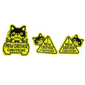 Set of three reflective magnetic stickers showing cat, panda, and duck designs on a metal surface.