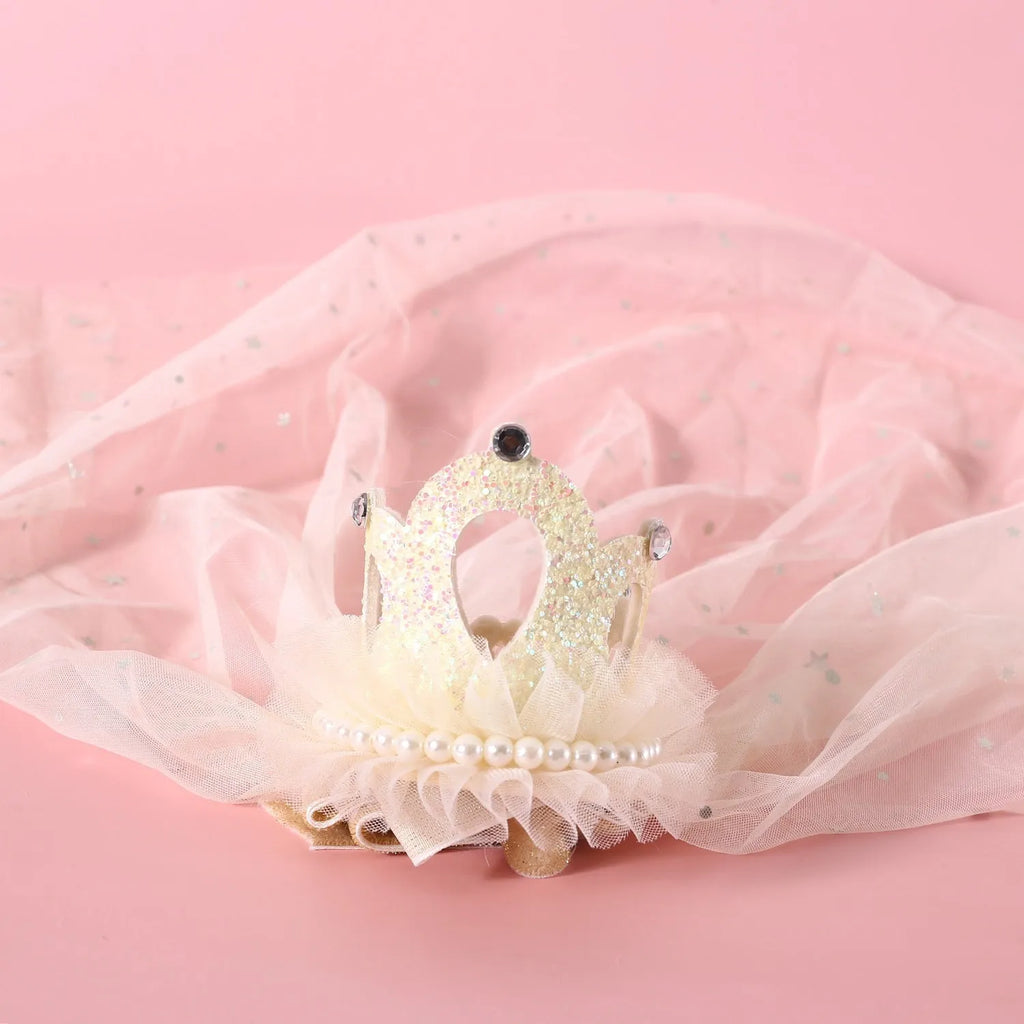 Cat wearing princess crown headdress with veil in beige or pink colour for wedding celebrations