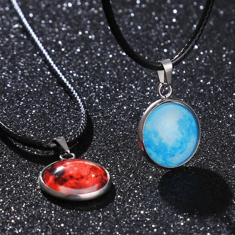 Luminous alloy moon and constellation pendant necklace with a coloured glass cabochon on a chain.
