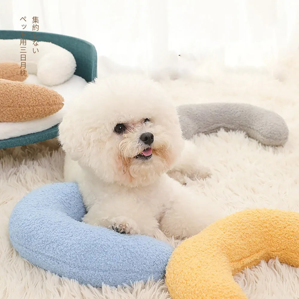U-shaped blue cat pillow with adjustable neck collar on a sofa
