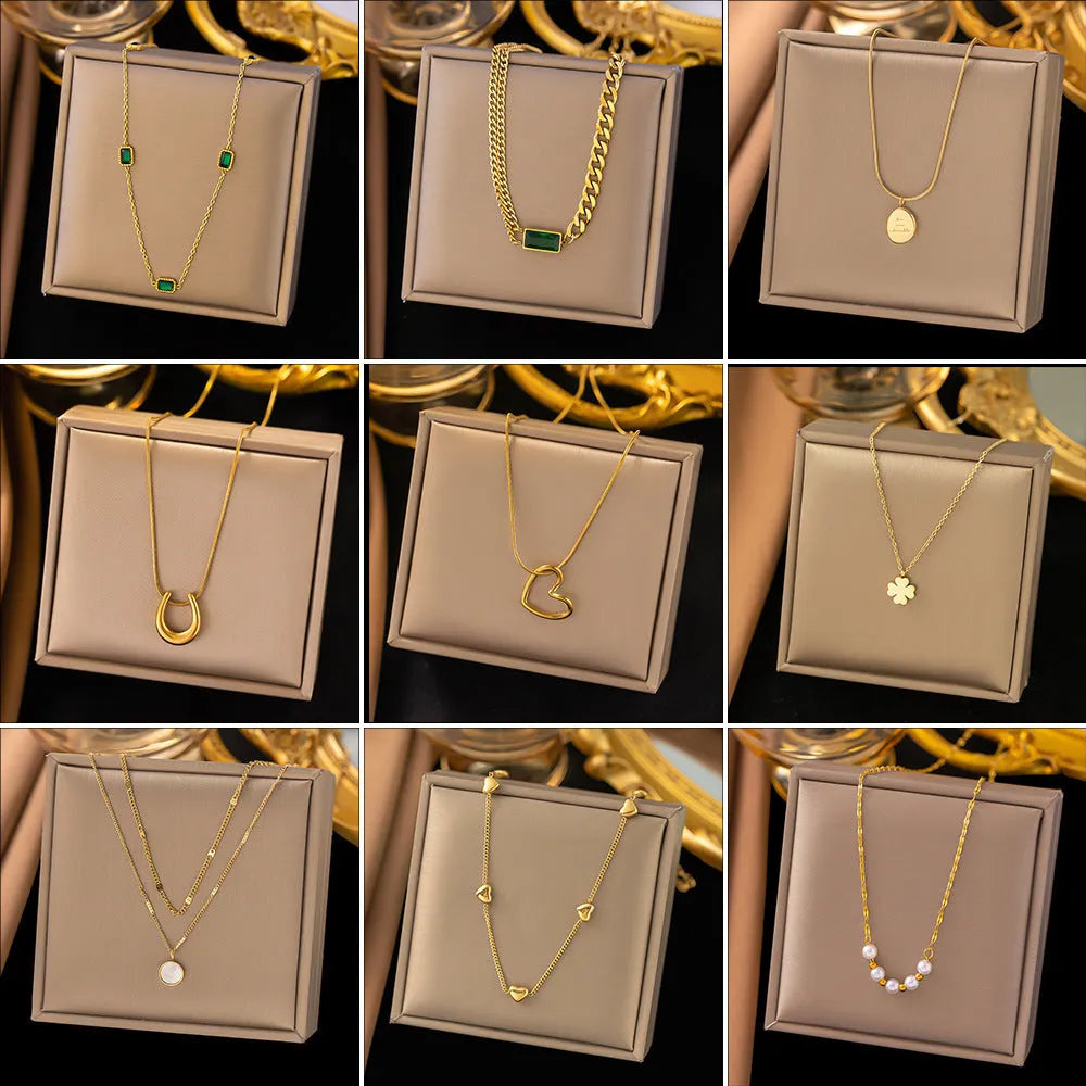 Gold titanium steel necklace with double ring pendant on a regular chain, listed as 37 H6012