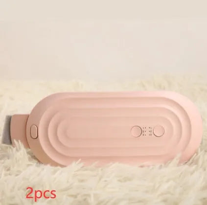Pink and white menstrual heating belt with USB charger, controller, and long cable on a grey background.