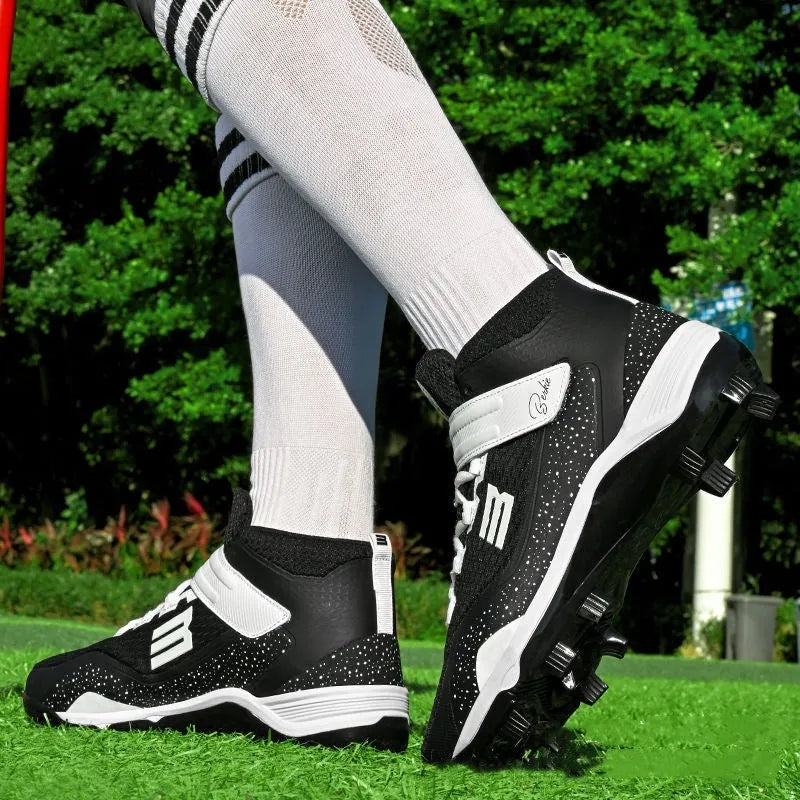 Black and white mid-top sports sneakers with Velcro straps and a textured rubber outsole.