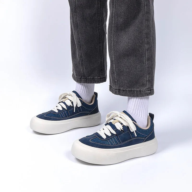 Men's black canvas platform lace-up trainers with a raised heel on a white background