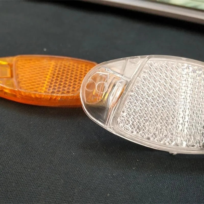 Yellow and white bicycle spoke reflector safety decorations showing dimensions and plastic construction
