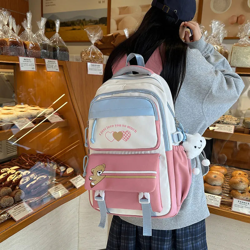 Nylon burden alleviation backpack for girls in pink long leg cloud design with outer sandwich pocket and stitching details