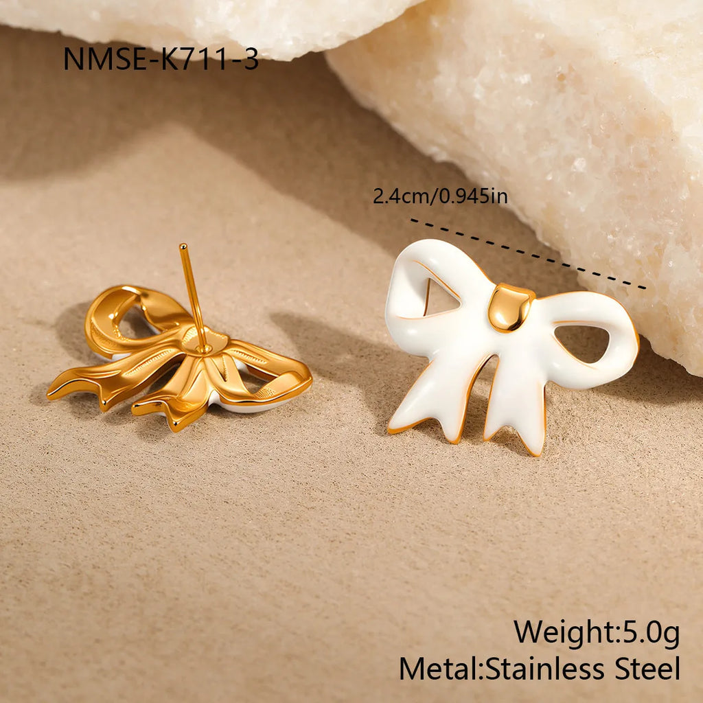 18K gold plated stainless steel bowknot necklace with adjustable chain and matching stud earrings on white background
