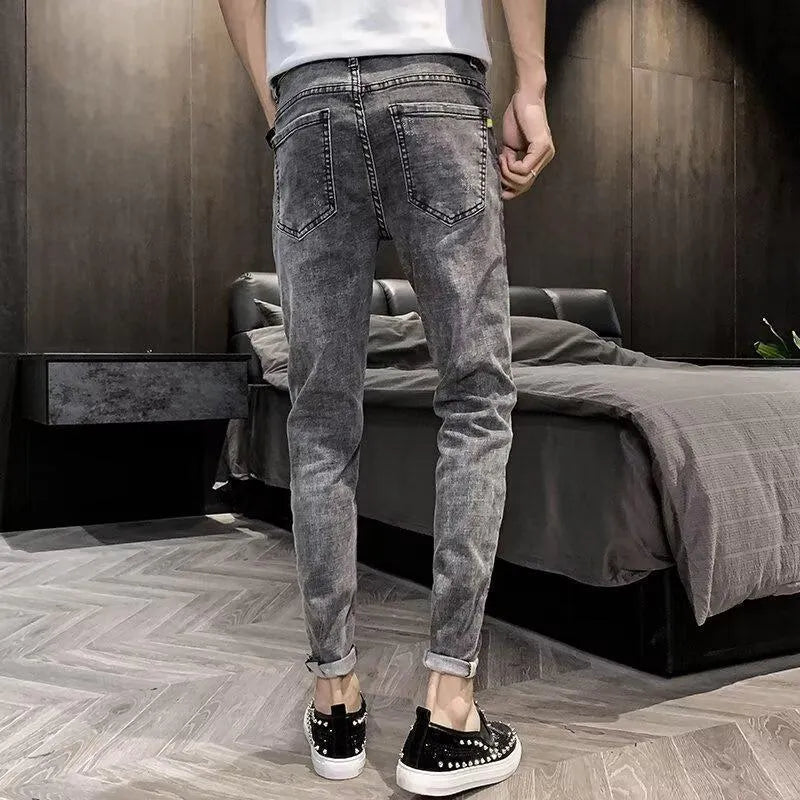 Men's blue denim jeans with high waist, button fly, and straight leg design on hanger