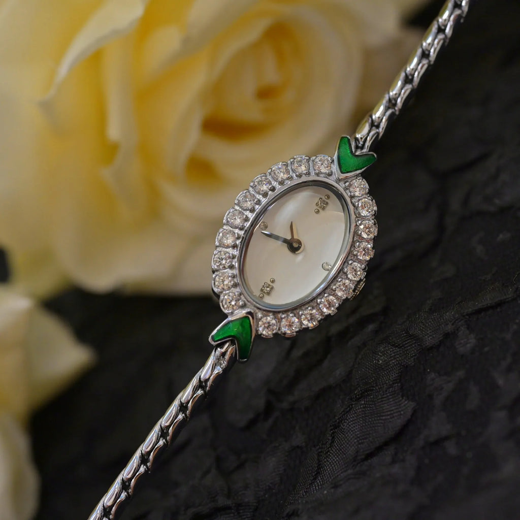 Small European-style gold women's watch with rhinestone inlay, 316L stainless steel case, and synthetic sapphire dial mirror on adjustable strap