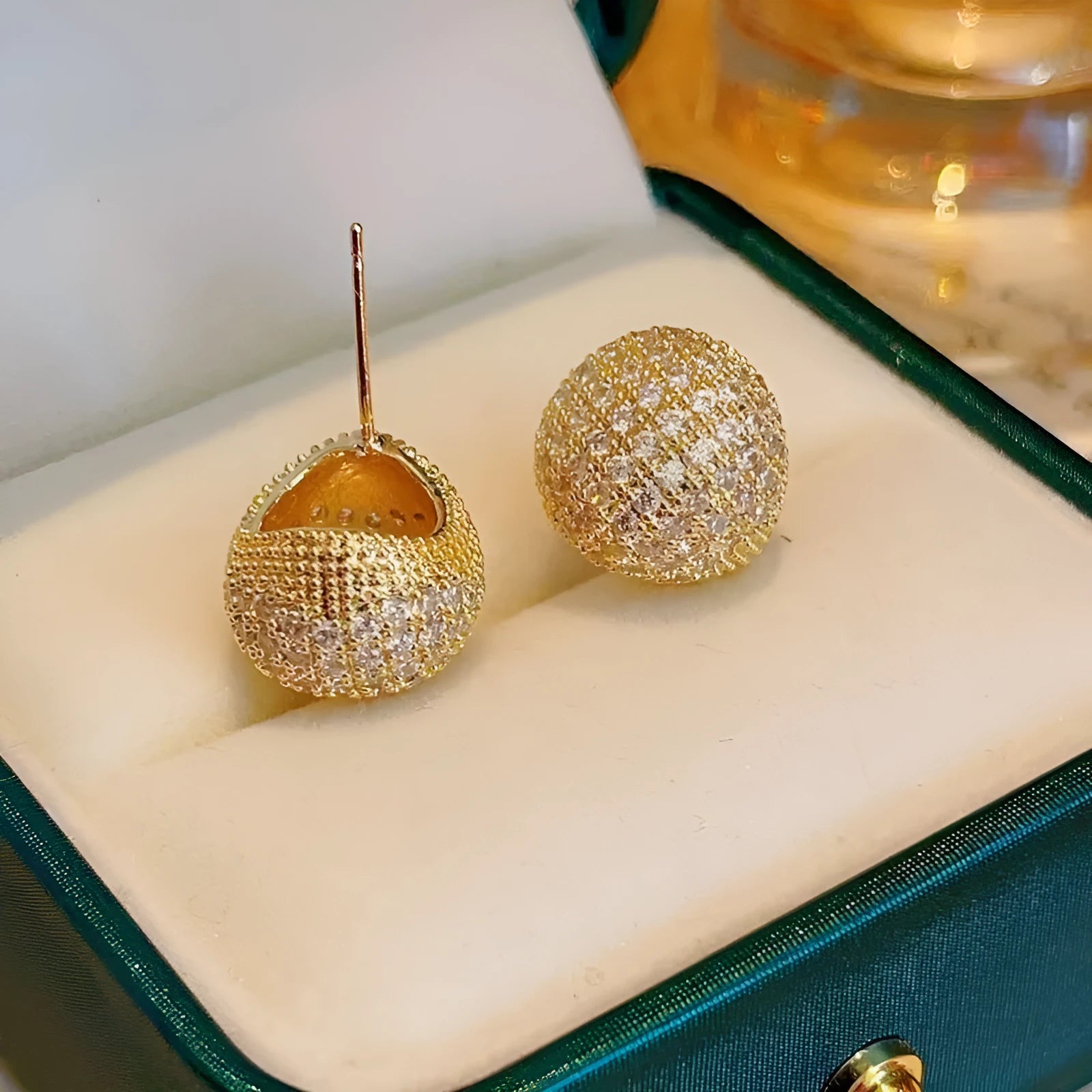 Geometric drop earrings with full diamond pave on golden spherical components in gold and white colour options