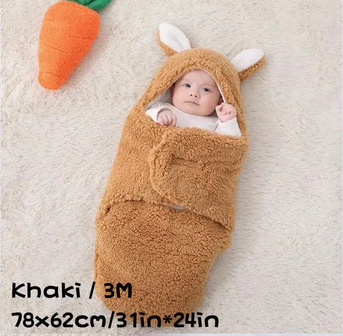 A baby wearing a soft grey fleece sleeping bag with hook-and-loop shoulder straps.