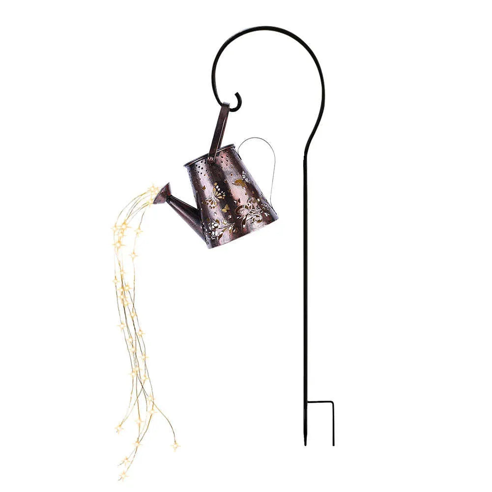 Iron solar garden lamp with a tapered butterfly silhouette emitting warm white light.