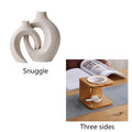 Two European ceramic vases with glazed snuggle colour finish, set on a shelf for creative home decoration