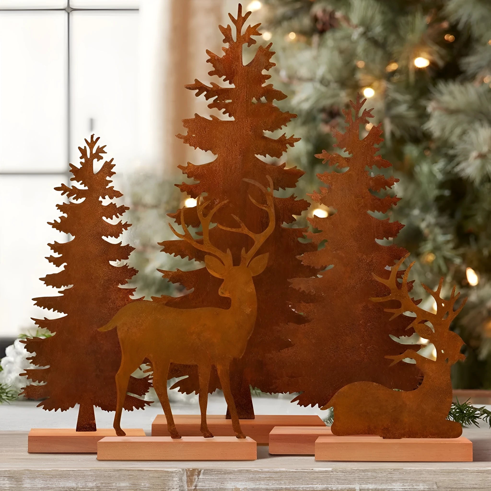 Set of three rusty iron Christmas tree decorations with standing elk figures