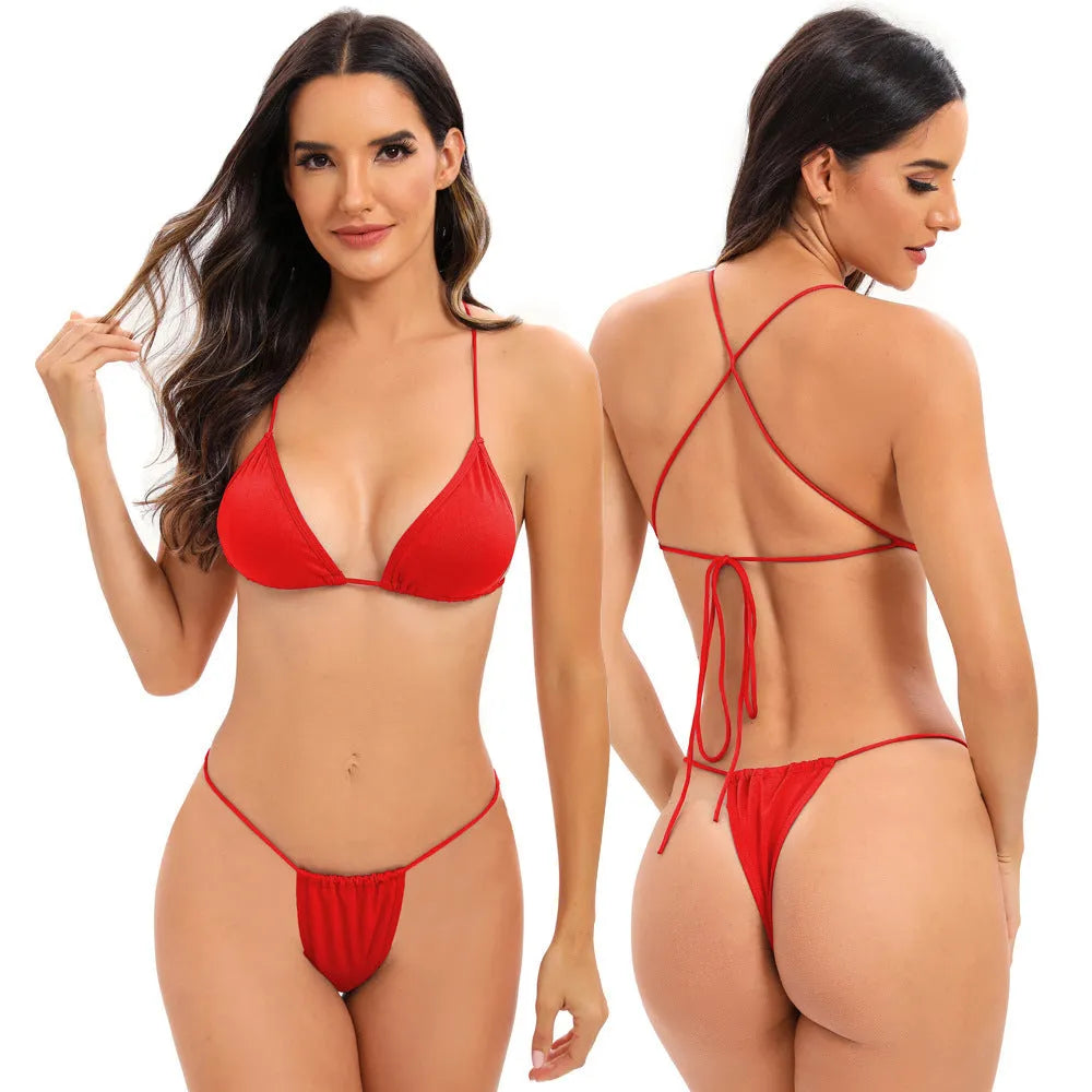 Women's candy coloured cross strap split swimsuit with multiple straps on a mannequin.