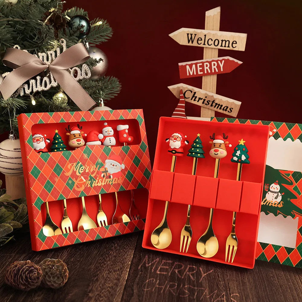Red stainless steel Christmas spoon and fork set with snowman and Christmas tree designs on the handles.