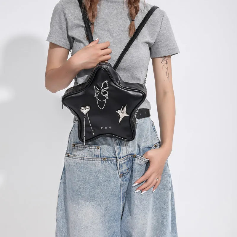 Black women's PU backpack with metal butterfly pendant, chain strap, and an outer 3D pocket.