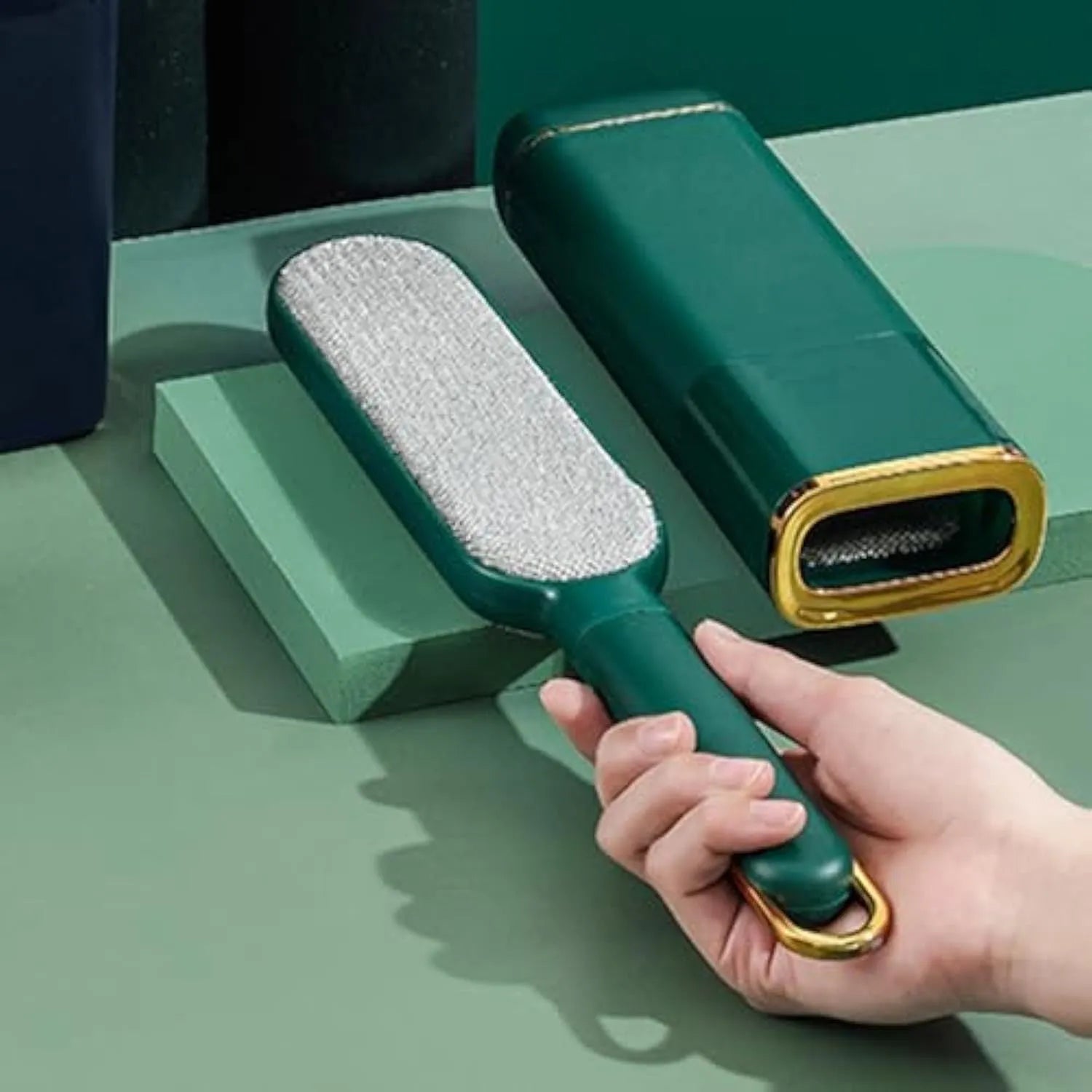 Blue, green, and white pet hair remover brush with a storage box base.