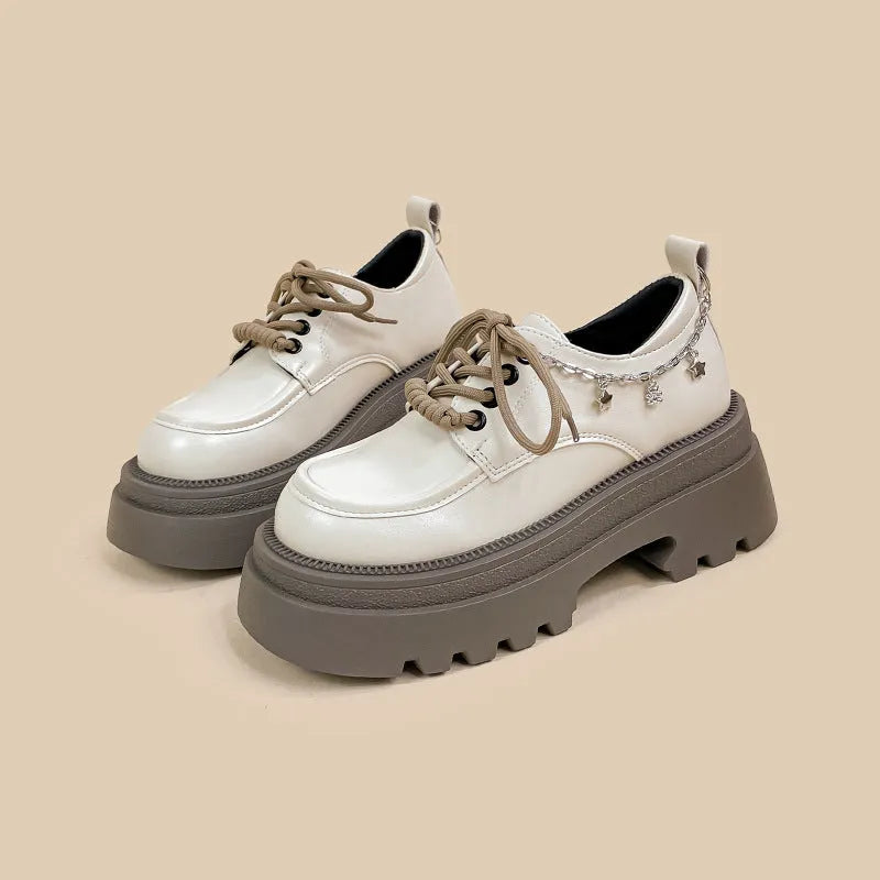 White platform Mary Jane shoes with chunky heel and lace-up front