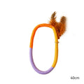 Circular green cotton rope cat toy with feathers and catnip for interactive feline play