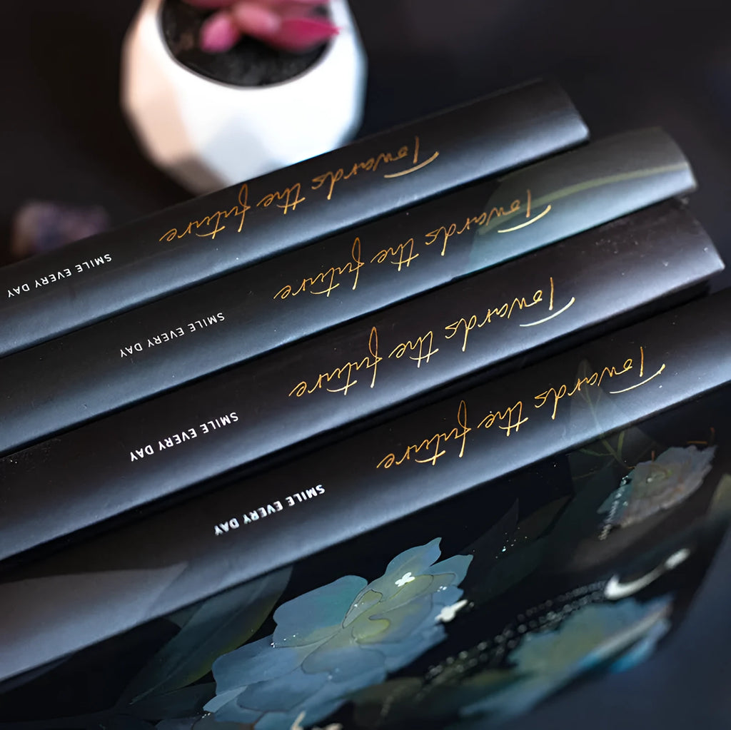 A5 size notebook with a luminous reflective cover, open to show internal pages with colour illustrations.
