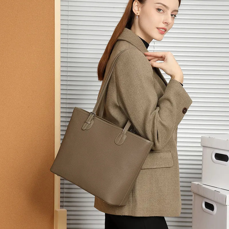 Women's genuine leather tote bag 30cm wide in black colour showing internal zipper compartments and retro styling