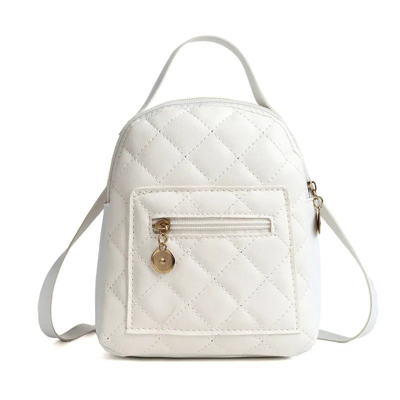 Girls' hard-case embroidered backpack in pink, showing front design and shoulder straps.