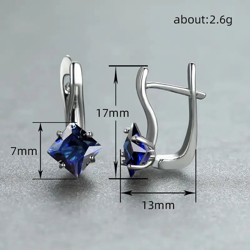A pair of women's copper earrings with a diamond design featuring inlaid blue zircon stones.