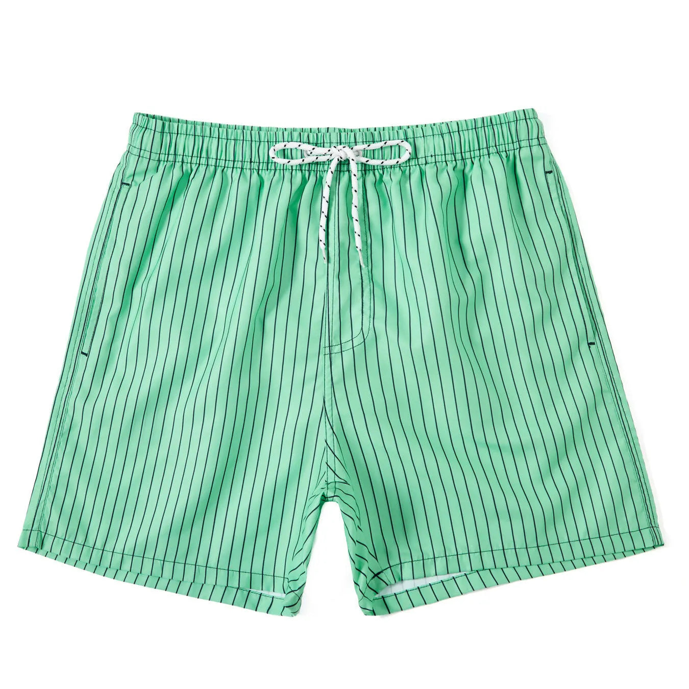 Man wearing navy blue and white striped straight-leg polyester beach shorts on shore.