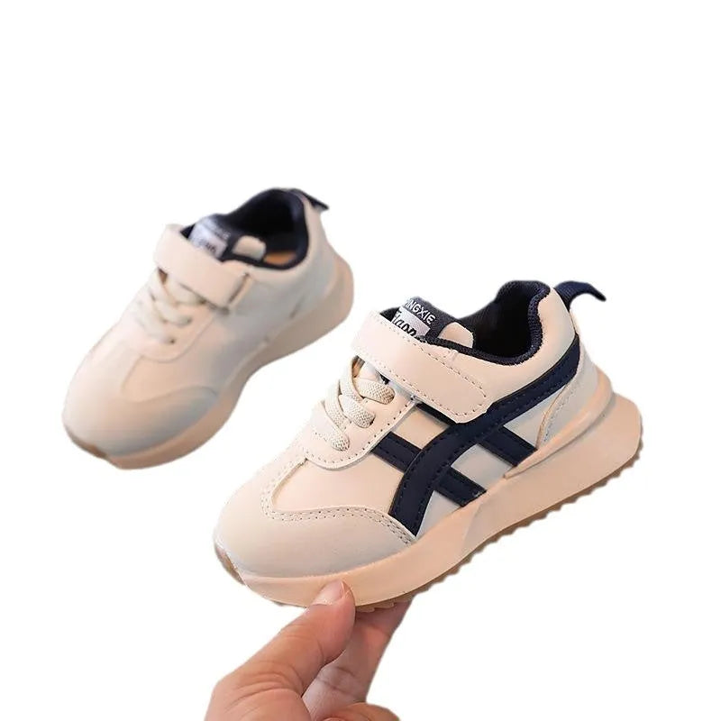 Children's white casual sneaker with Velcro strap, synthetic leather upper, and rubber sole