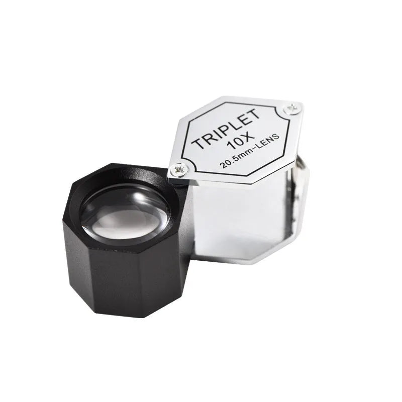 Handheld metal portable magnifying glass for jewellery and coin identification with optical glass lenses.