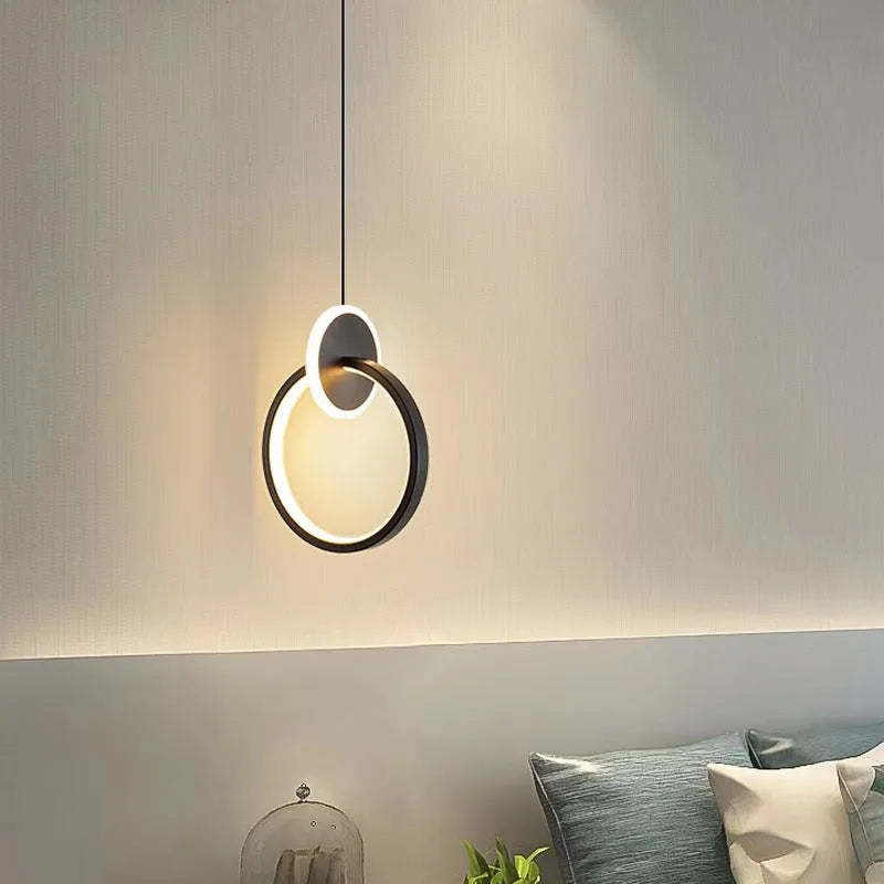 Modern black double ring Nordic pendant lamp hanging from ceiling with adjustable cable.