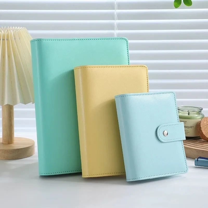 A5 PU leather zipper binder notebook shell shown in multiple solid colours including pink, blue, and black.