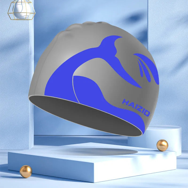 Silicone swimming cap with whale tail pattern and built-in ear protectors in choice of colours