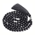 Long geometric agate and gemstone tassel necklace showing colourful beads including amethyst and lapis lazuli.