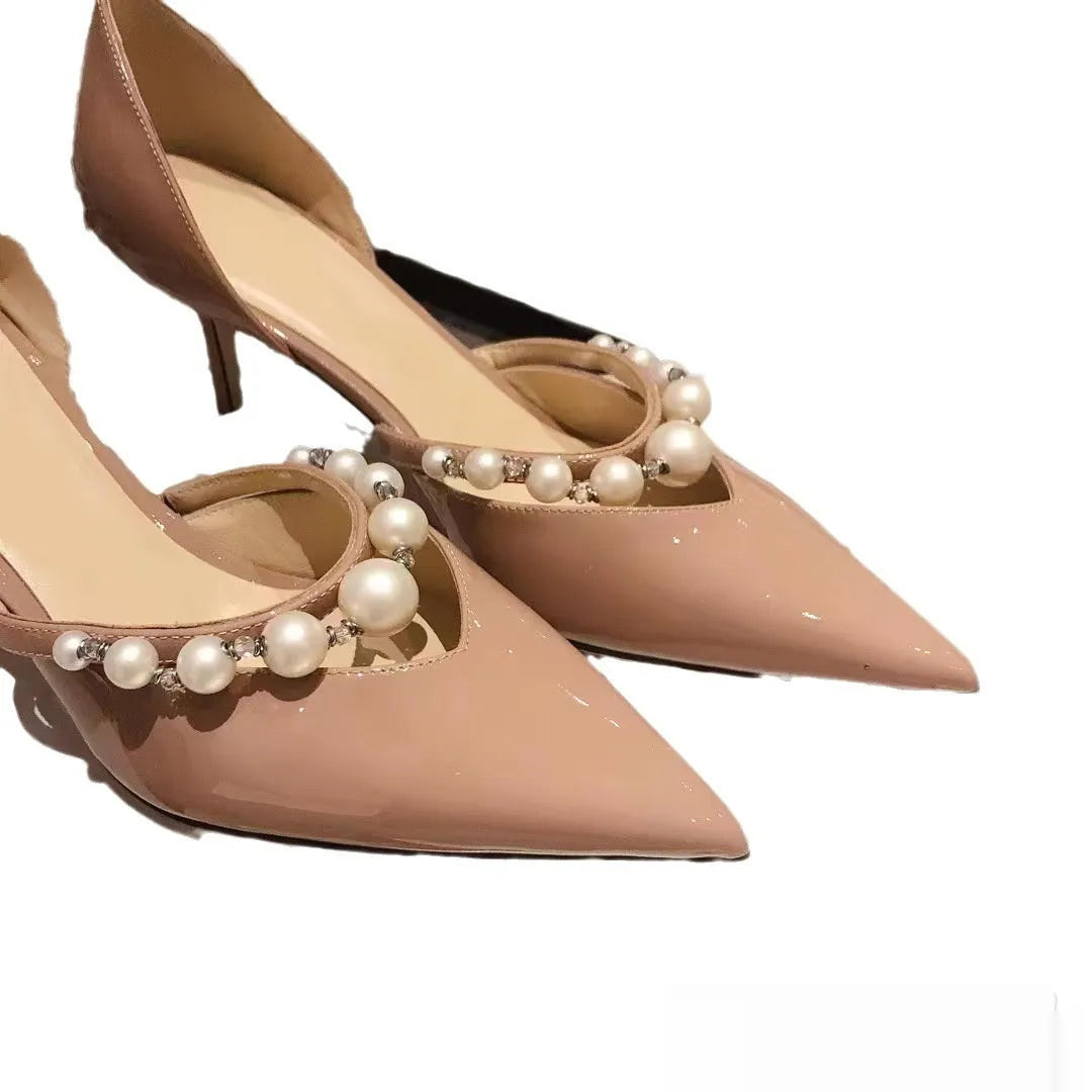 Women's pointed patent leather stiletto high heels with pearl decoration, shown in an oversleeve design.