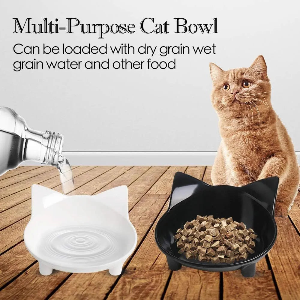 A shallow black melamine pet bowl with a non-slip rubber base on a kitchen surface.