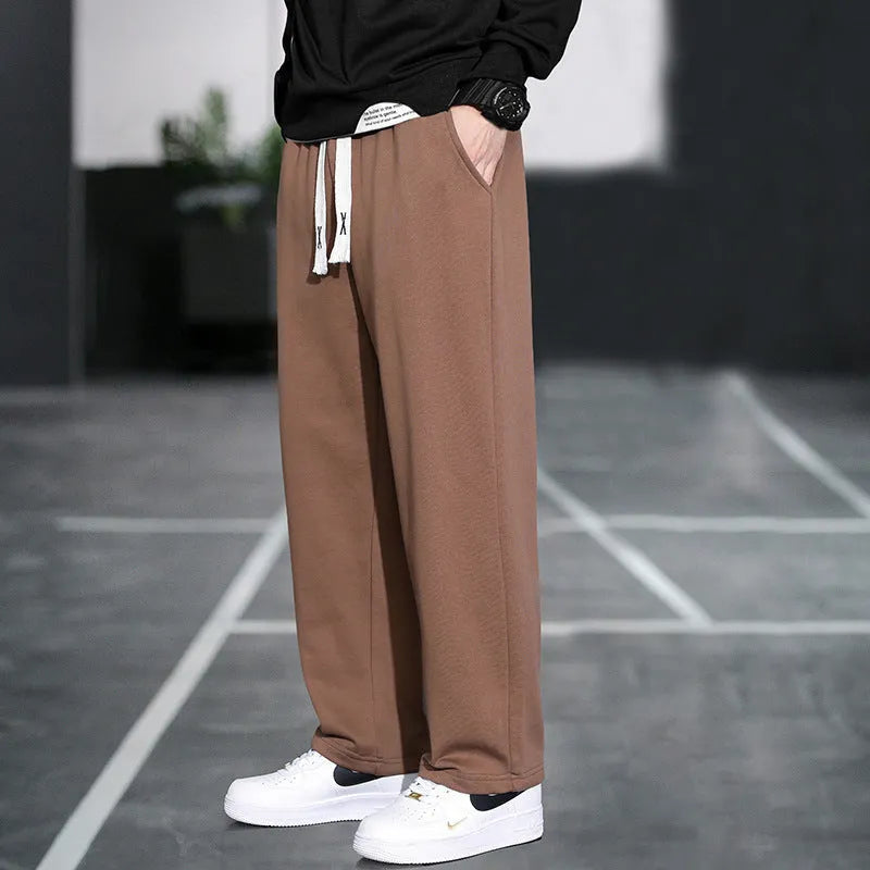 Men's grey casual trousers with multiple pockets showing high waist design and full length