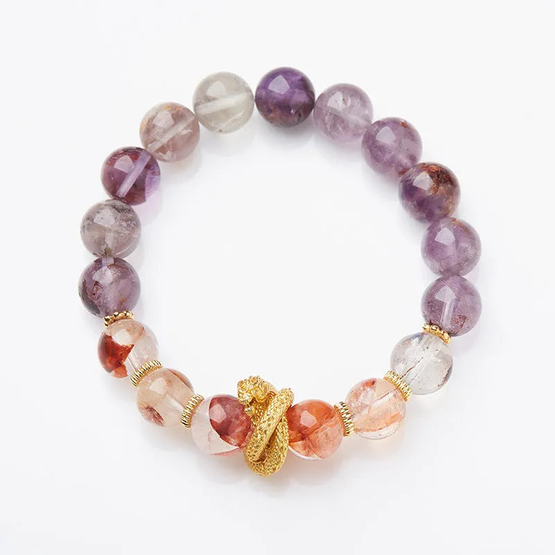 Purple cornucopia crystal bracelet with nine purple lucky charms on wrist