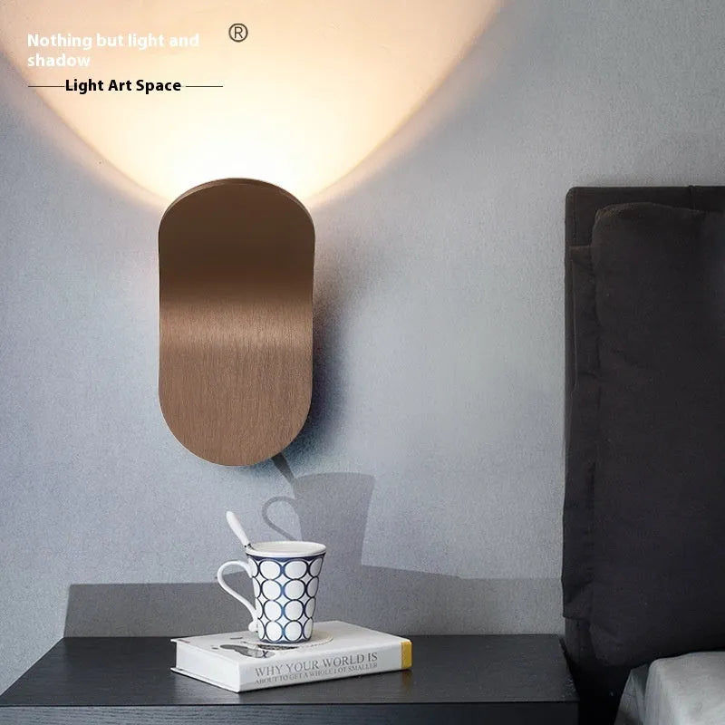 Modern simple wall lamp in brushed gold finish mounted on living room wall