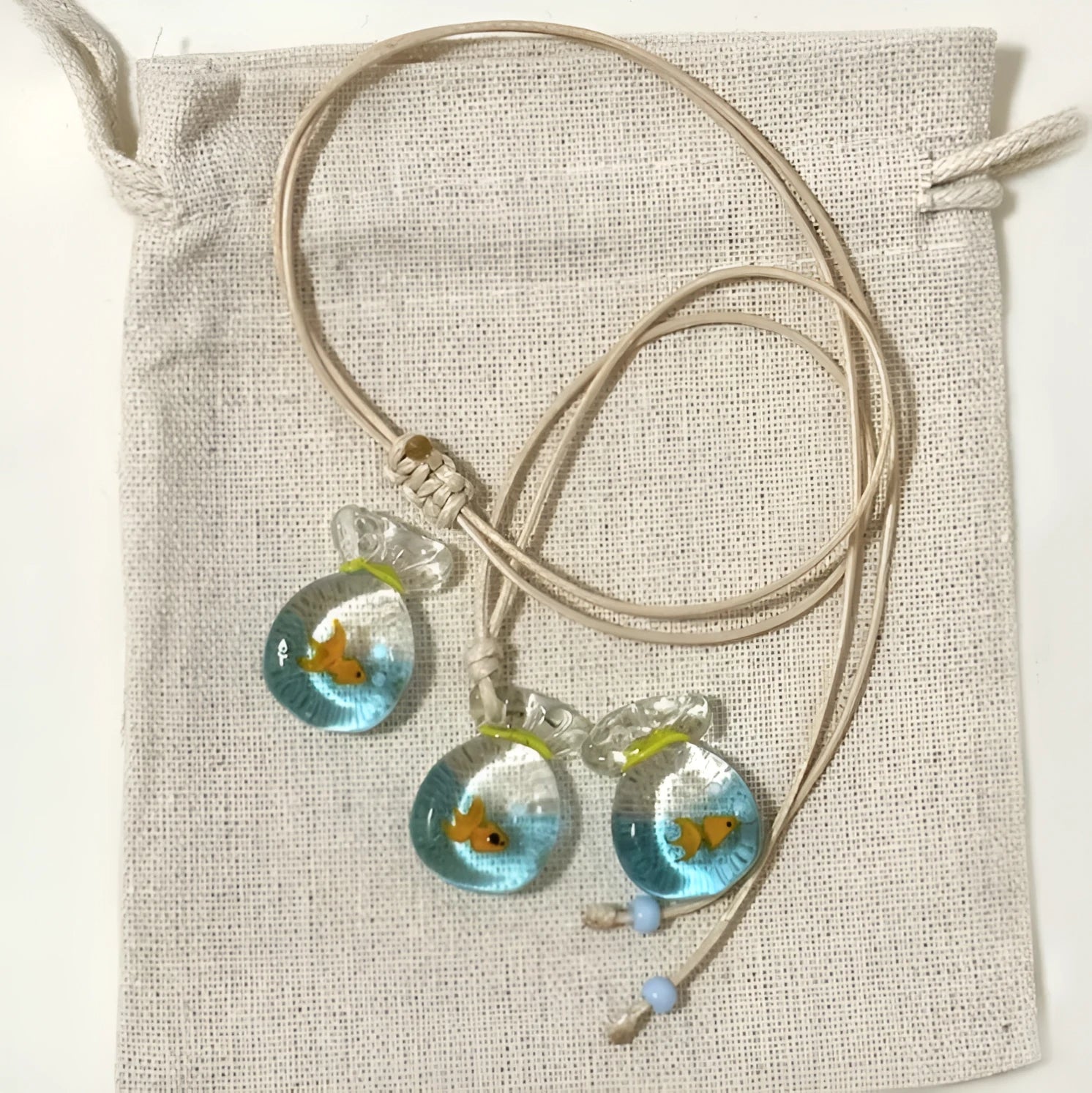 Women's pendant necklace with a coloured glaze skirt-shaped joker charm on a cotton and linen clavicle chain.