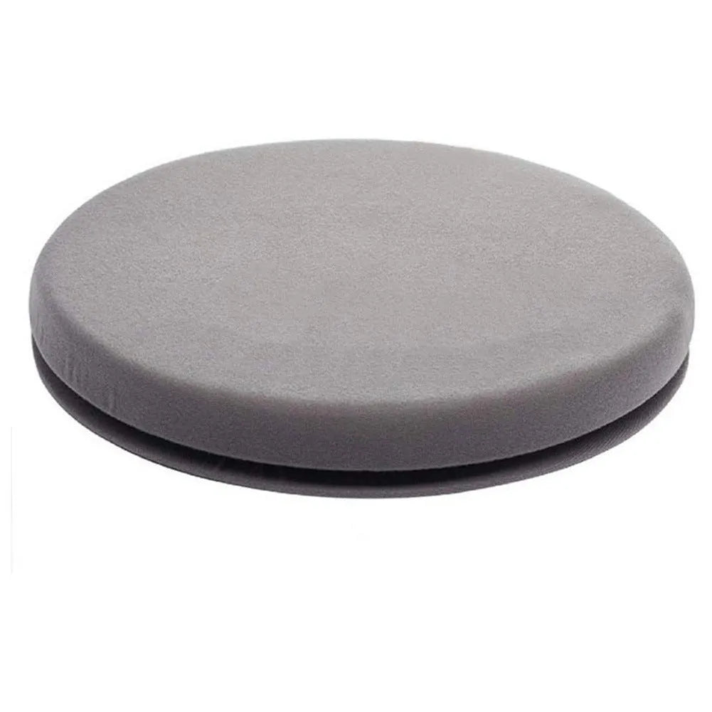 Grey rotating car seat cushion with plush fabric on a car seat, showing swivel function.