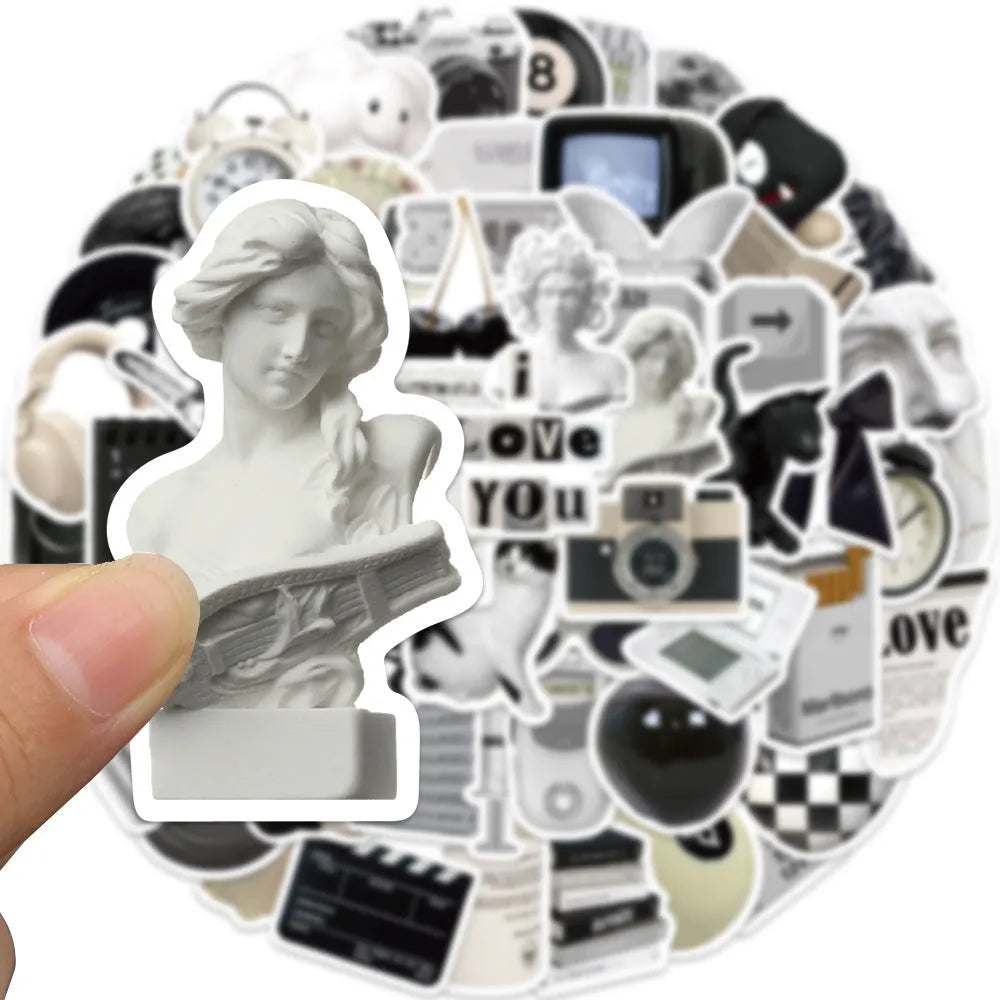 Assortment of 61 black and white line-art PVC stickers for laptops and luggage.