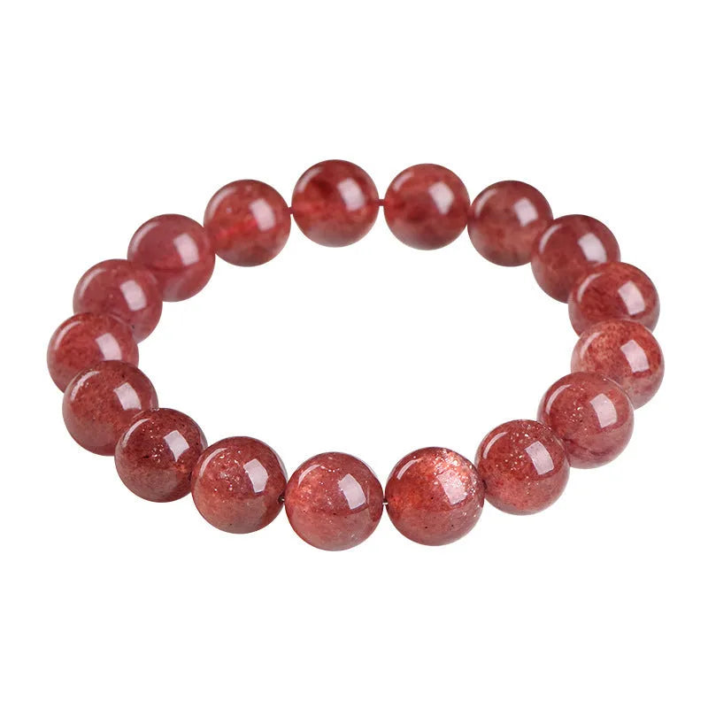 Natural cherry red strawberry quartz bracelet with geometric beads on a wrist.